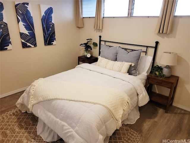 bedroom with dark hardwood / wood-style floors