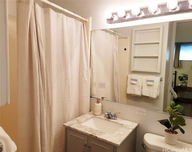 bathroom featuring vanity, toilet, and a shower with shower curtain