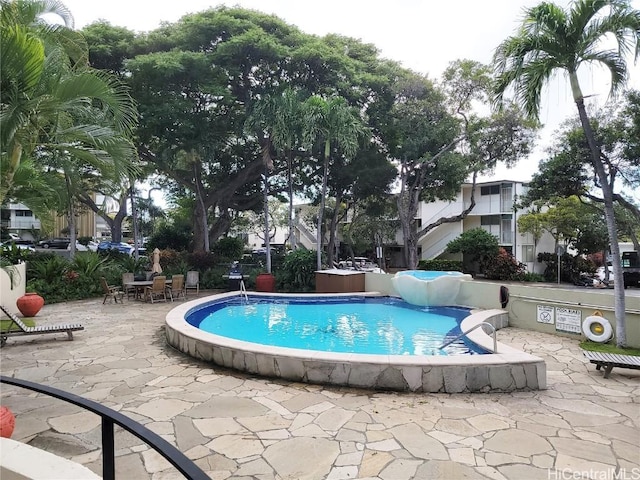 view of swimming pool featuring a patio area