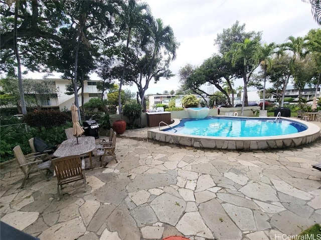 view of swimming pool with a patio area