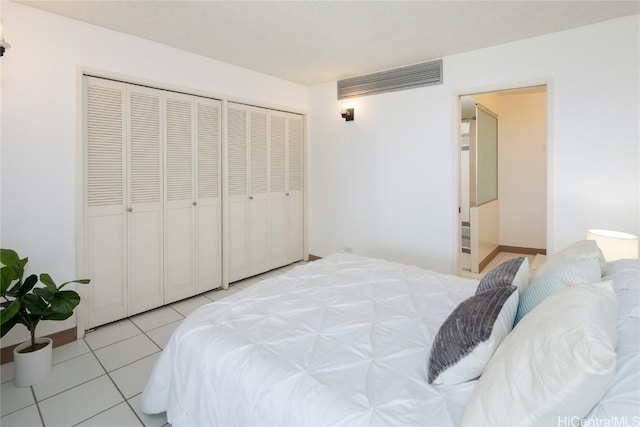 tiled bedroom featuring a closet