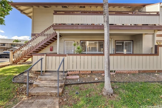 view of side of home featuring stairs