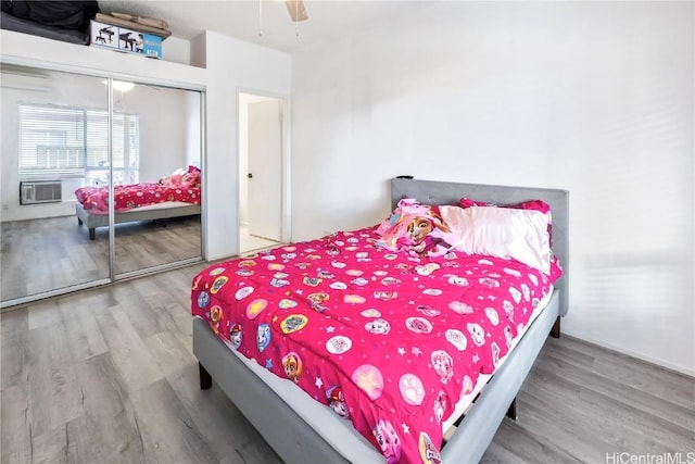 bedroom featuring a closet, a ceiling fan, and wood finished floors