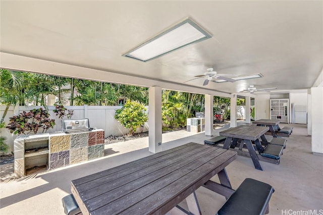 view of patio / terrace with outdoor dining area, area for grilling, fence, and a ceiling fan