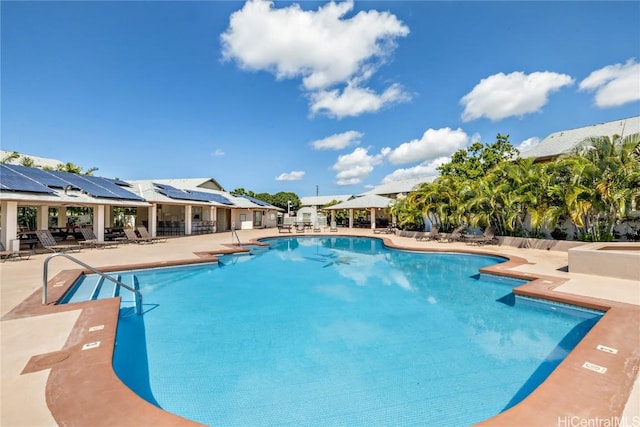 community pool with a patio area and a gazebo