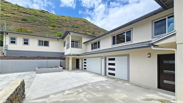 exterior space featuring a garage and a mountain view