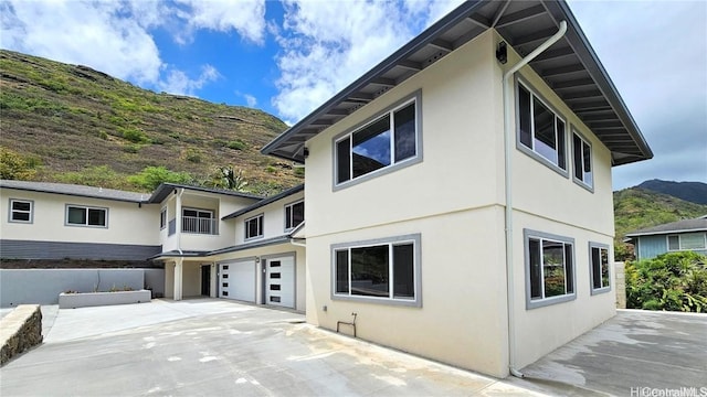 view of home's exterior featuring a garage and a mountain view