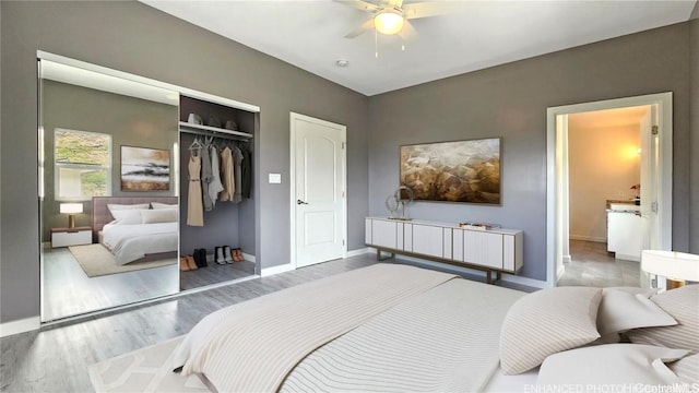 bedroom featuring ceiling fan, hardwood / wood-style floors, and a closet