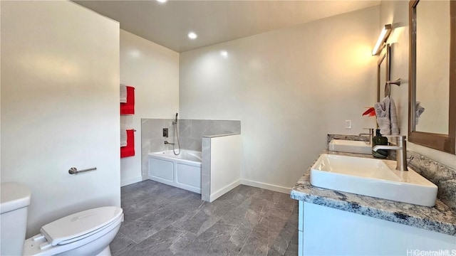 bathroom with vanity, toilet, and a bathing tub