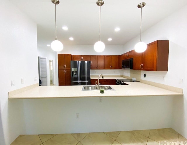 kitchen with a sink, a peninsula, electric range oven, and black fridge