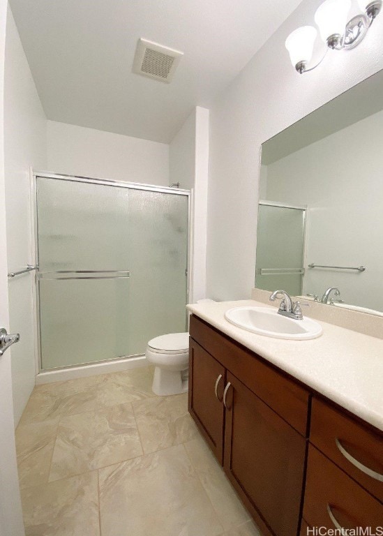 full bathroom featuring toilet, vanity, a shower with door, and visible vents