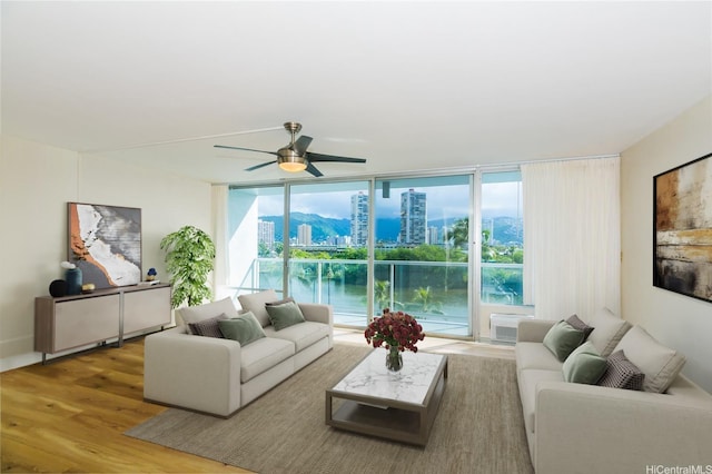 2233 Ala Wai Blvd Unit 5B, Honolulu, HI 96815 - living area featuring a city view, expansive windows, wood finished floors, and ceiling fan