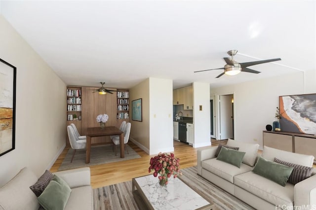 living room with light hardwood / wood-style floors and ceiling fan