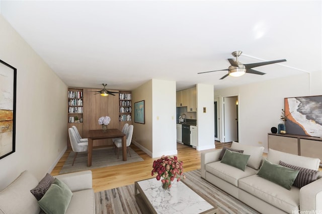 2233 Ala Wai Blvd Unit 5B, Honolulu, HI 96815 - living room featuring ceiling fan, baseboards, and light wood finished floors