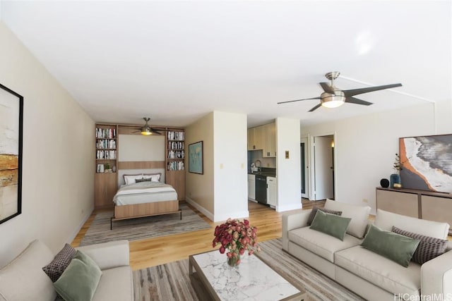 living room with light hardwood / wood-style flooring and ceiling fan