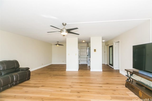 living room with light hardwood / wood-style floors and ceiling fan