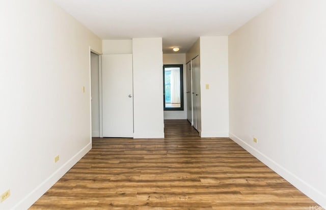 2233 Ala Wai Blvd Unit 5B, Honolulu, HI 96815 - unfurnished bedroom with baseboards and wood finished floors