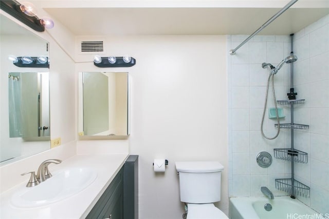 full bathroom with tiled shower / bath combo, vanity, and toilet