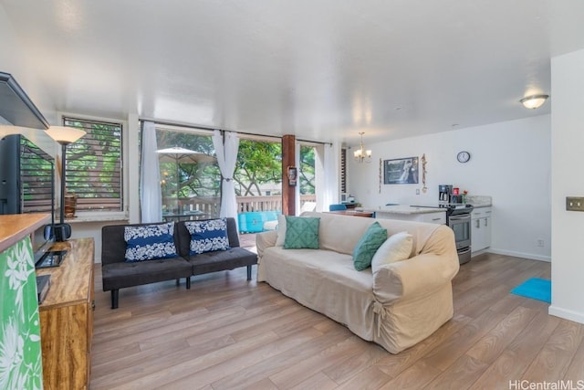 living room featuring an inviting chandelier and light wood-type flooring