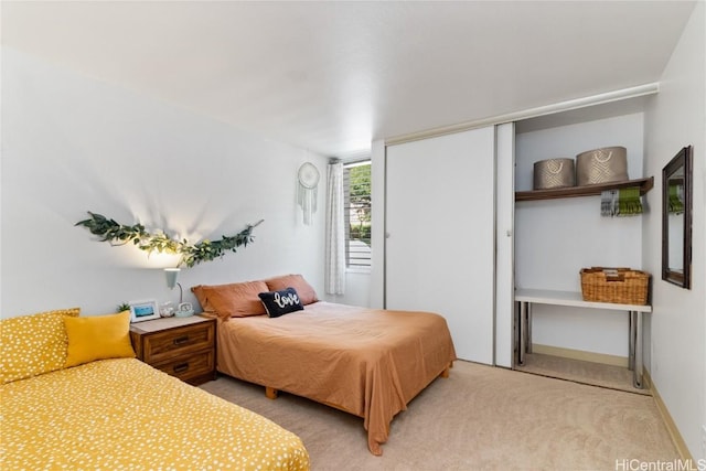 bedroom with a closet, carpet, and baseboards