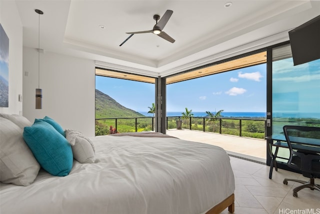 tiled bedroom with multiple windows, ceiling fan, and access to exterior