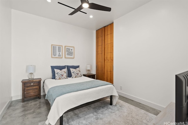 bedroom featuring finished concrete floors, recessed lighting, a ceiling fan, and baseboards