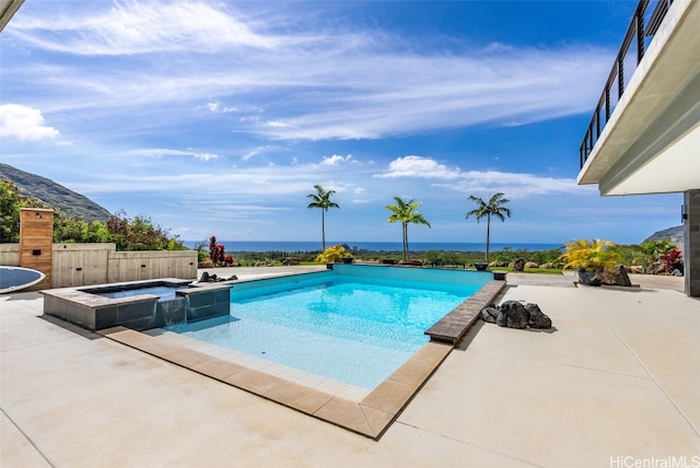 view of pool with a pool with connected hot tub and a patio