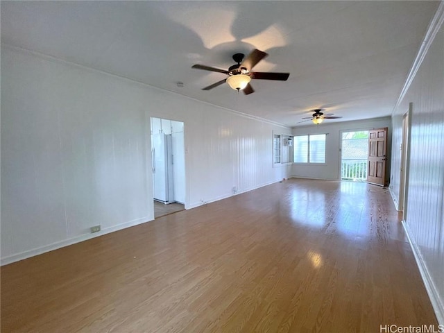 spare room with wood-type flooring, ornamental molding, and ceiling fan