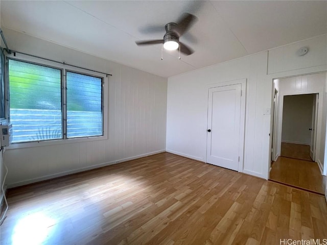 empty room featuring ceiling fan and light hardwood / wood-style flooring