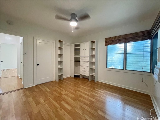 unfurnished bedroom with ceiling fan, light hardwood / wood-style floors, and multiple closets