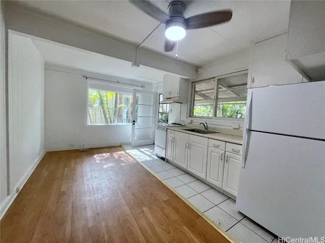 kitchen featuring white cabinetry, light wood-type flooring, sink, white appliances, and ceiling fan