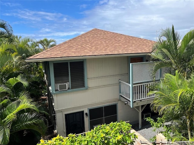 view of property exterior featuring cooling unit and a balcony