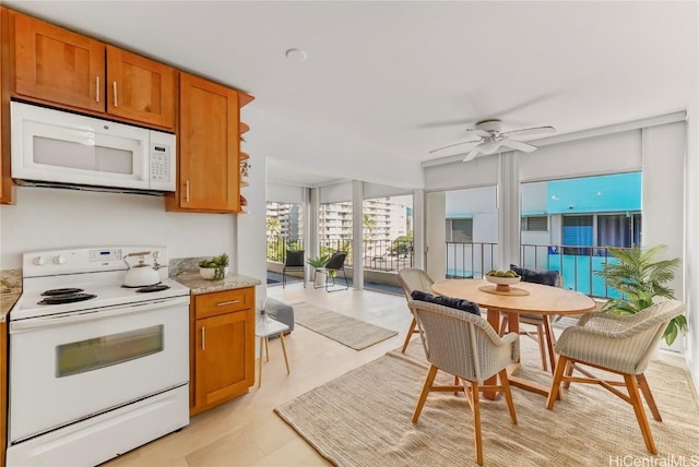 kitchen featuring ceiling fan and white appliances