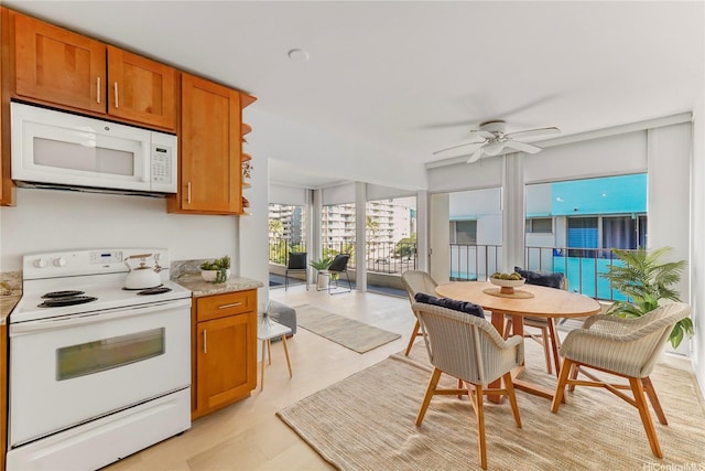 222 Kaiulani Ave Unit Ph4, Honolulu, HI 96815 - kitchen with white appliances, brown cabinets, ceiling fan, and open floor plan