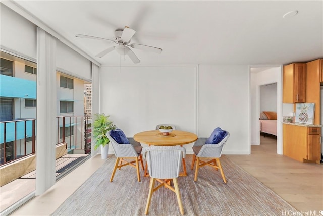 dining room featuring light hardwood / wood-style floors and ceiling fan