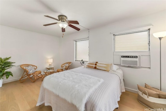 bedroom with ceiling fan and light wood-type flooring