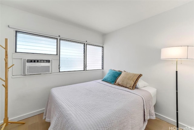 bedroom featuring cooling unit and light hardwood / wood-style flooring