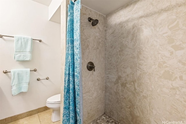 bathroom featuring tile patterned flooring, toilet, and walk in shower