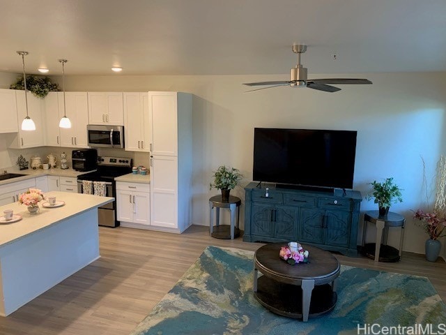 interior space with light hardwood / wood-style flooring and ceiling fan