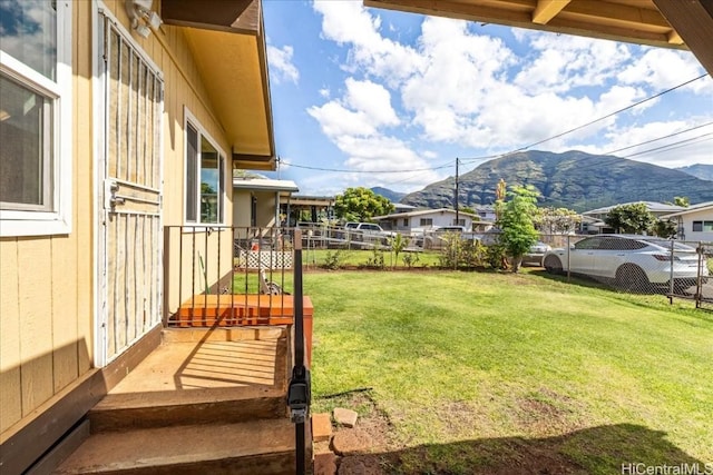 view of yard featuring fence and a mountain view