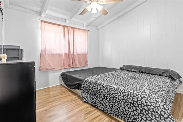 bedroom with vaulted ceiling with beams, wood finished floors, and a ceiling fan