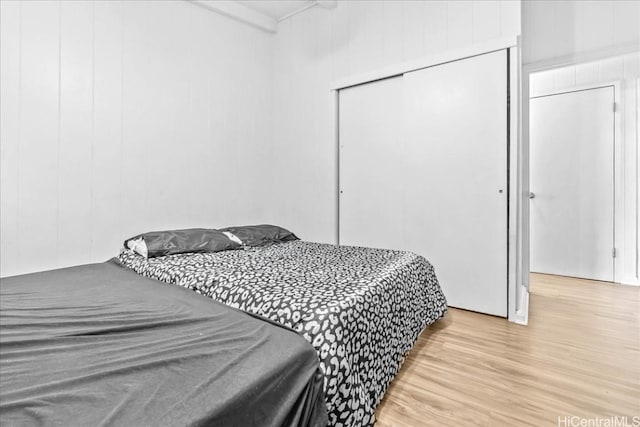 bedroom featuring a closet and light wood-style flooring