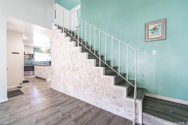 stairway with hardwood / wood-style flooring