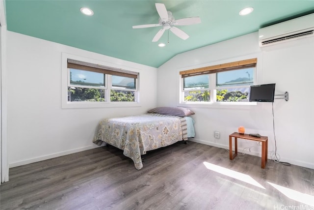 bedroom featuring hardwood / wood-style flooring, ceiling fan, lofted ceiling, and a wall unit AC