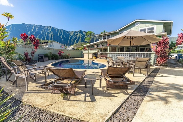 view of swimming pool with a mountain view and a patio area