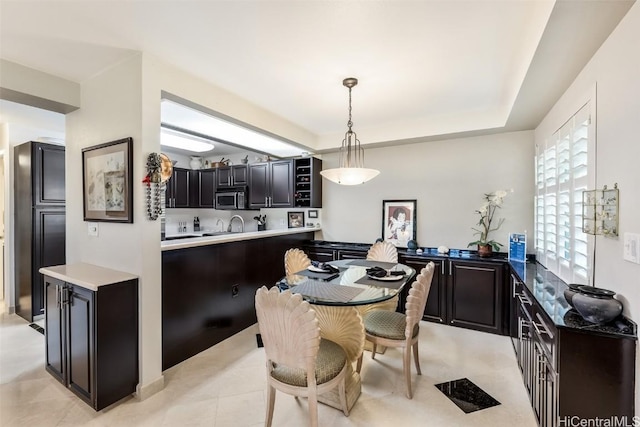 dining area with a raised ceiling