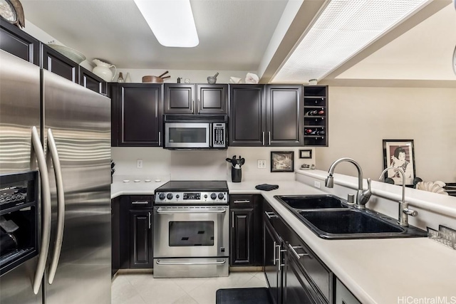 kitchen featuring sink, light tile patterned flooring, and appliances with stainless steel finishes