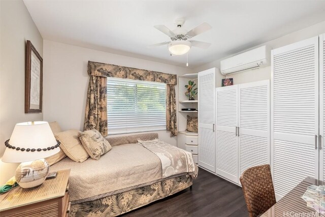 bedroom with a wall mounted air conditioner, wood-type flooring, and ceiling fan