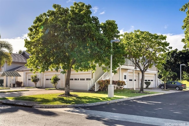 obstructed view of property with a front yard