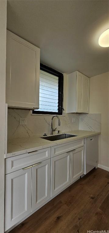 kitchen featuring dark wood-type flooring, sink, and white cabinets